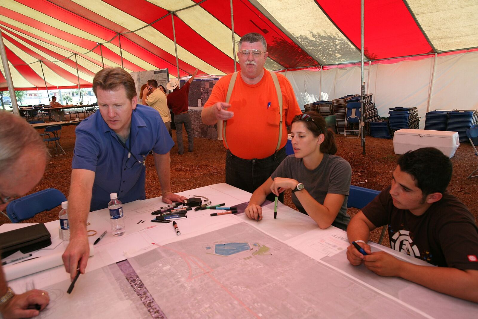 Greensburg, KS, July 19, 2007 - Mayor John Janssen, orange shirt, works with community planners and FEMA coordinators for the rebuilding of his town. Residents want the new town to be more energy efficient, community oriented, and attractive after rebuilding. Leif Skoogfors/FEMA