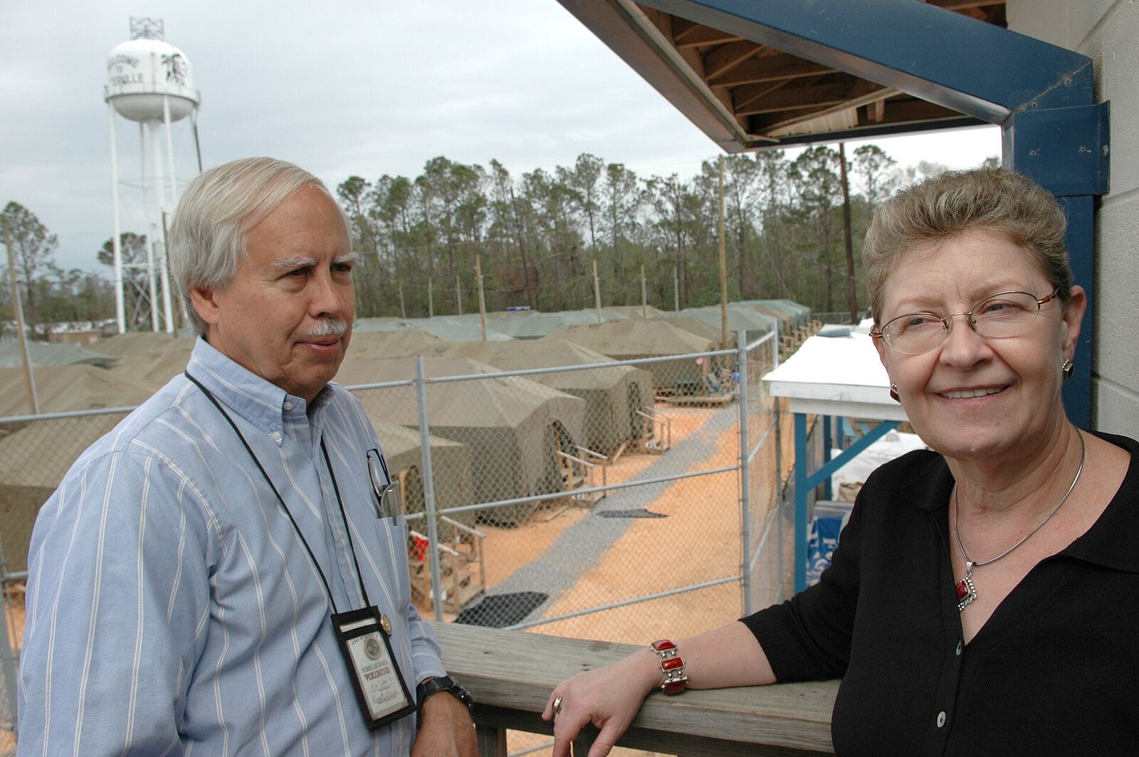 D'Iberville, Miss., March 16, 2006 -- Ed Cake, Ph.D. (left) and Irene McIntosh, Ph.D., Vice-President and President, respectively, of the D'Iberville Volunteers Foundation discuss the foundation's efforts outside their office. Dr. Cake and Dr. McIntosh are both residents of the area and became involved to ensure a fast, strong recovery for the community. They are volunteers. Mark Wolfe/FEMA