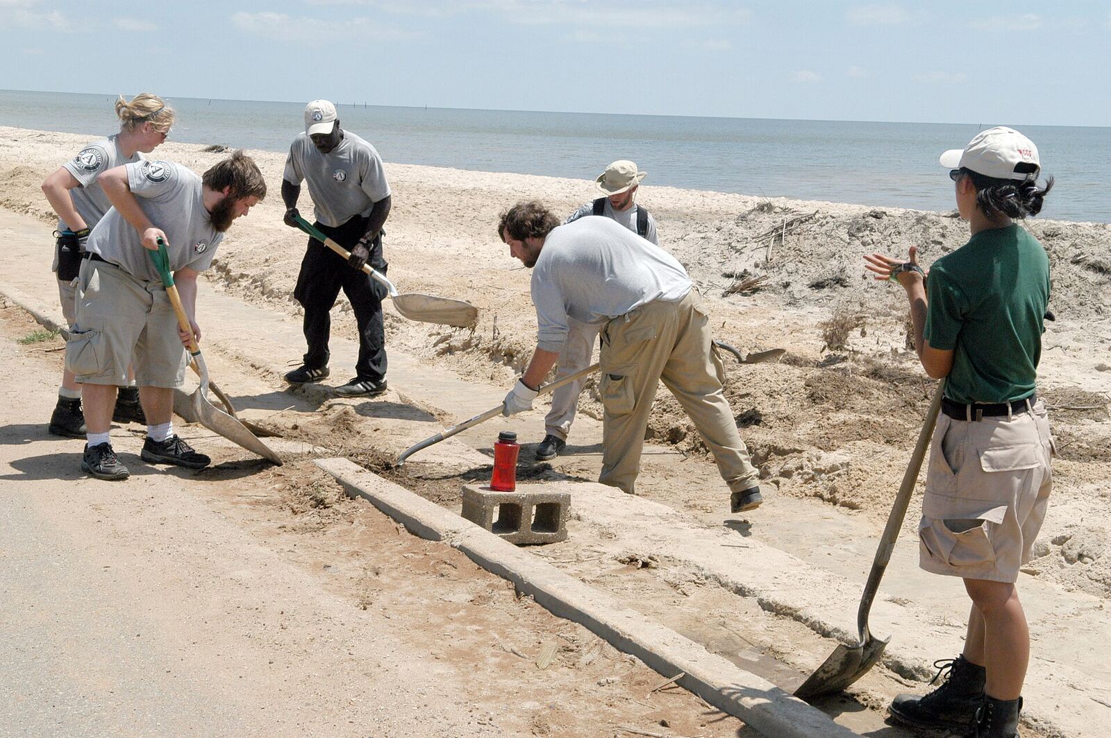 Waveland, Miss., April 22, 2006 - An AmeriCorps*NCCC team cleans debris from sidewalks along Waveland beach. The largest gathering of AmeriCorps*NCCC members in history is sponsoring a massive cleanup event in honor of National and Global Youth Service Day today. George Armstrong/FEMA